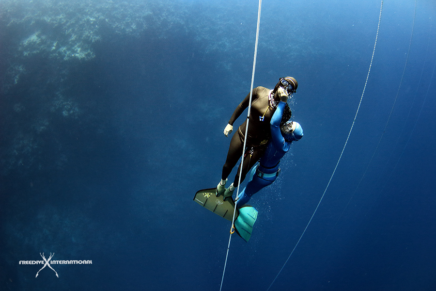 Diver with a monofin rescues her buddy